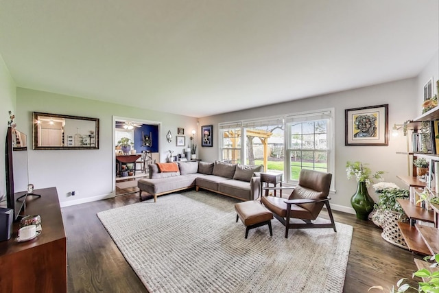 living room featuring baseboards and dark wood-style floors