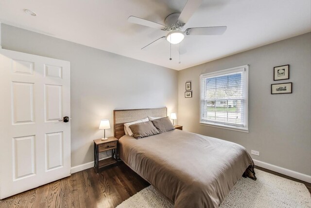 bedroom with wood finished floors, baseboards, and a ceiling fan