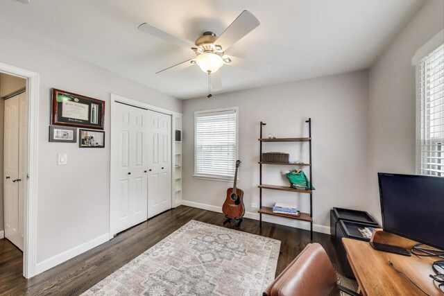 office space featuring a ceiling fan, baseboards, and wood finished floors