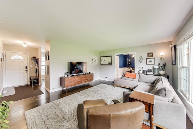 living room featuring dark wood-style flooring and baseboards