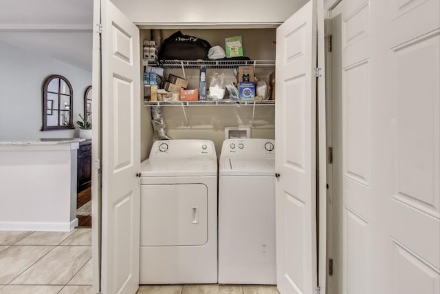 laundry room featuring separate washer and dryer and light tile patterned floors