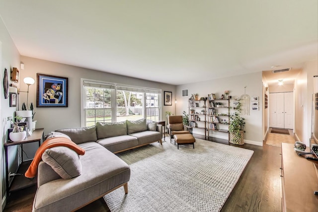 living area featuring wood finished floors and baseboards