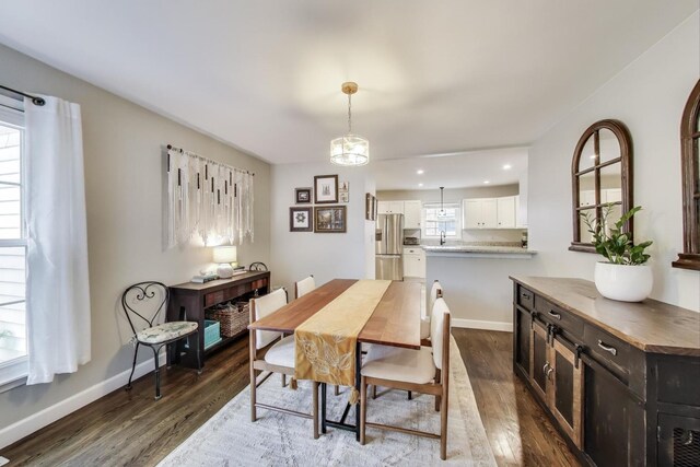 dining space featuring dark wood-style flooring, baseboards, and recessed lighting