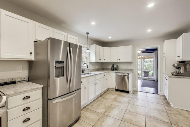kitchen with stainless steel appliances, a sink, white cabinets, light tile patterned flooring, and recessed lighting