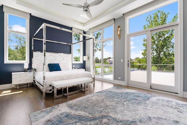 bedroom with baseboards, access to exterior, and multiple windows