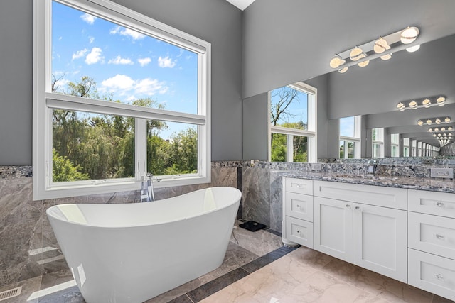 bathroom with visible vents, tile walls, marble finish floor, and a wainscoted wall