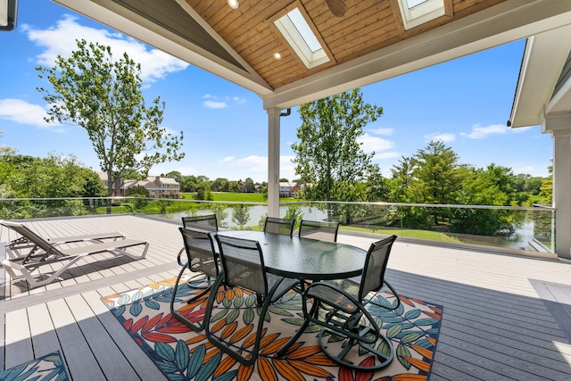 wooden deck with outdoor dining space and a water view
