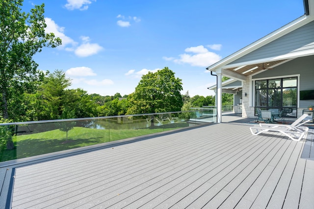 wooden terrace featuring a water view