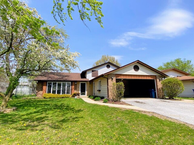 5210 Arquilla Dr, Richton Park, IL 60471 - view of front of house with brick siding, aphalt driveway, a front yard, and a garage