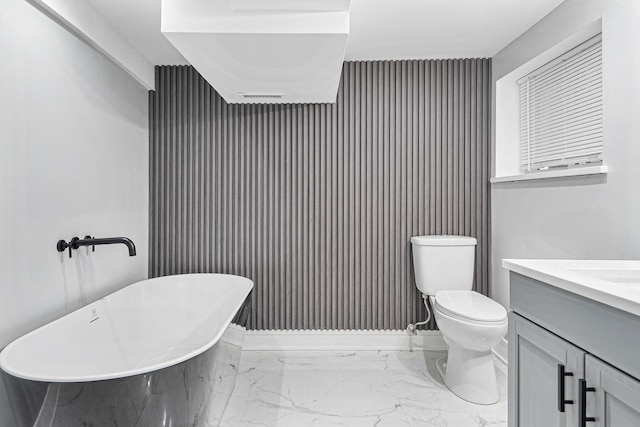 8543 S Laflin St, Chicago, IL 60620 - bathroom featuring vanity, toilet, marble finish floor, a freestanding tub, and visible vents