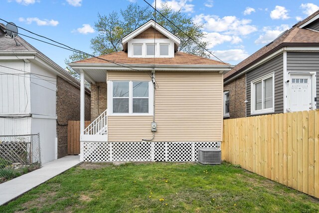 8543 S Laflin St, Chicago, IL 60620 - exterior space featuring a lawn, fence, central AC, and roof with shingles