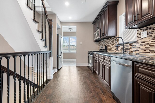 8543 S Laflin St, Chicago, IL 60620 - kitchen with dark brown cabinets, a sink, stainless steel appliances, backsplash, and dark wood-style floors