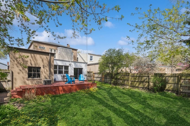 1804 Cleveland St, Evanston, IL 60202 - rear view of house with a lawn, a chimney, cooling unit, a deck, and a fenced backyard