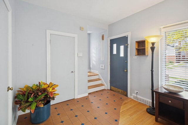 1804 Cleveland St, Evanston, IL 60202 - entrance foyer featuring visible vents, baseboards, tile patterned flooring, and stairs
