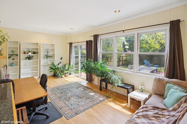 office with crown molding, wood walls, and wood finished floors