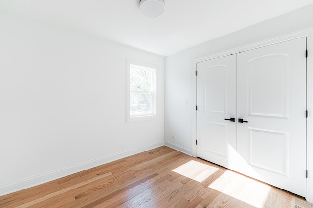 4134 W Roscoe St, Chicago, IL 60641 - unfurnished bedroom featuring light wood finished floors, baseboards, and a closet