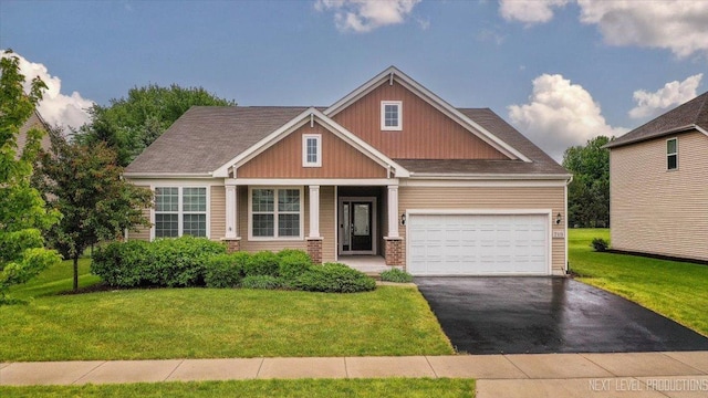719 Foxborough Rd, South Elgin, IL 60177 - craftsman inspired home featuring asphalt driveway, a front lawn, brick siding, and an attached garage