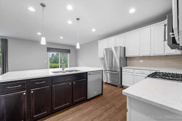 719 Foxborough Rd, South Elgin, IL 60177 - kitchen with appliances with stainless steel finishes, a sink, white cabinetry, dark wood-type flooring, and backsplash