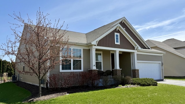 719 Foxborough Rd, South Elgin, IL 60177 - craftsman-style house with a porch, board and batten siding, a front lawn, driveway, and an attached garage