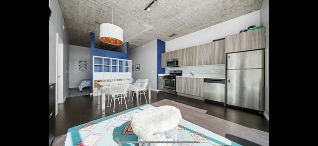 1345 S Wabash Ave Unit 502, Chicago, IL 60605 - kitchen featuring stainless steel appliances, modern cabinets, decorative backsplash, dark wood finished floors, and light countertops