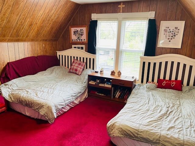 242 N Grove St, Carpentersville, IL 60110 - bedroom featuring carpet flooring, wood walls, and lofted ceiling