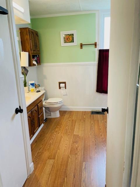 242 N Grove St, Carpentersville, IL 60110 - half bathroom featuring toilet, wood finished floors, and vanity