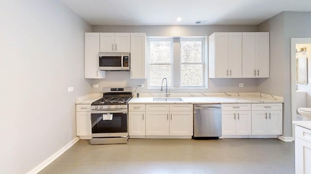 kitchen with white cabinetry, appliances with stainless steel finishes, and a sink