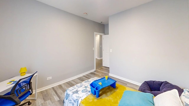 bedroom with baseboards and wood finished floors