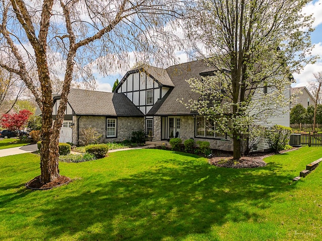 849 Brompton Cir, Bolingbrook, IL 60440 - tudor house featuring stone siding, central AC, a shingled roof, and concrete driveway
