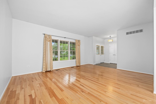 849 Brompton Cir, Bolingbrook, IL 60440 - unfurnished living room with hardwood / wood-style flooring and baseboards