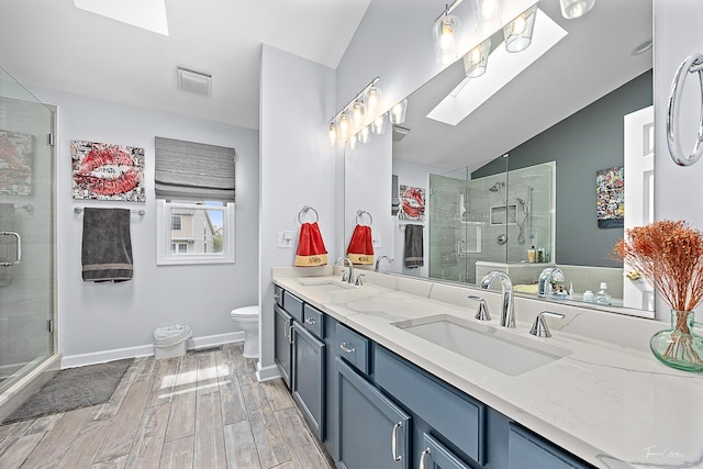 849 Brompton Cir, Bolingbrook, IL 60440 - full bath with double vanity, a shower stall, a skylight, wood finished floors, and lofted ceiling