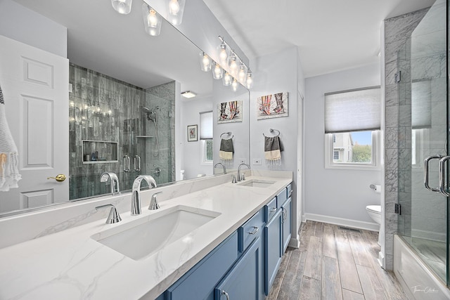 849 Brompton Cir, Bolingbrook, IL 60440 - bathroom featuring toilet, double vanity, a shower with shower door, wood finished floors, and baseboards