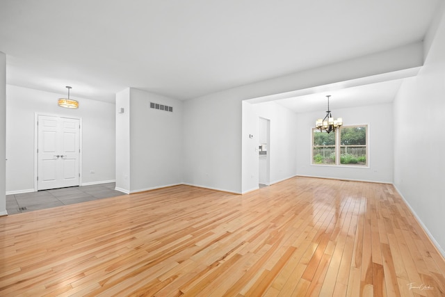 849 Brompton Cir, Bolingbrook, IL 60440 - unfurnished room with hardwood / wood-style flooring, a chandelier, and baseboards