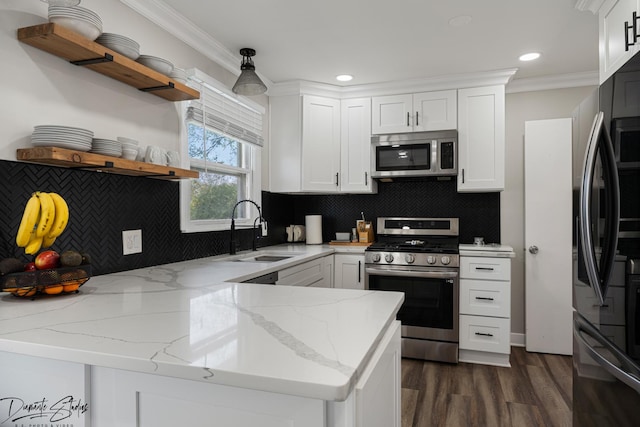 16121 S Harmony Dr, Plainfield, IL 60586 - kitchen featuring open shelves, appliances with stainless steel finishes, a sink, a peninsula, and white cabinetry