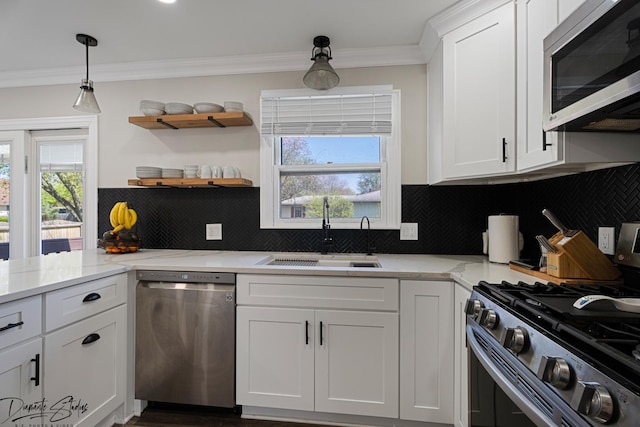 16121 S Harmony Dr, Plainfield, IL 60586 - kitchen with crown molding, appliances with stainless steel finishes, tasteful backsplash, a sink, and white cabinetry