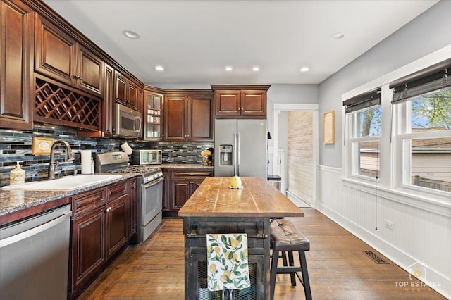 309 E Elm St, Villa Park, IL 60181 - kitchen with dark wood-style flooring, visible vents, appliances with stainless steel finishes, wainscoting, and a sink