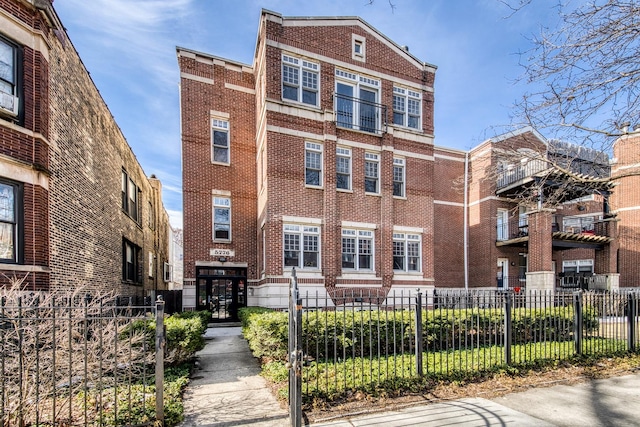 view of front facade with fence private yard and brick siding