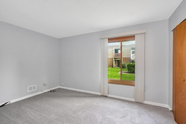 7330 Fairview Ave Unit 104, Downers Grove, IL 60516 - spare room featuring carpet floors, baseboards, and visible vents