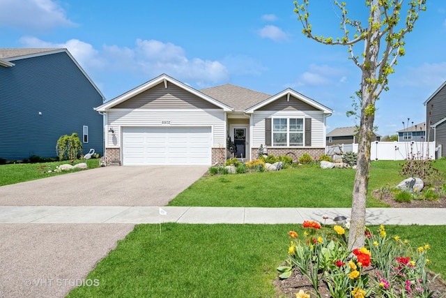 view of front of house featuring an attached garage, asphalt driveway, and brick siding