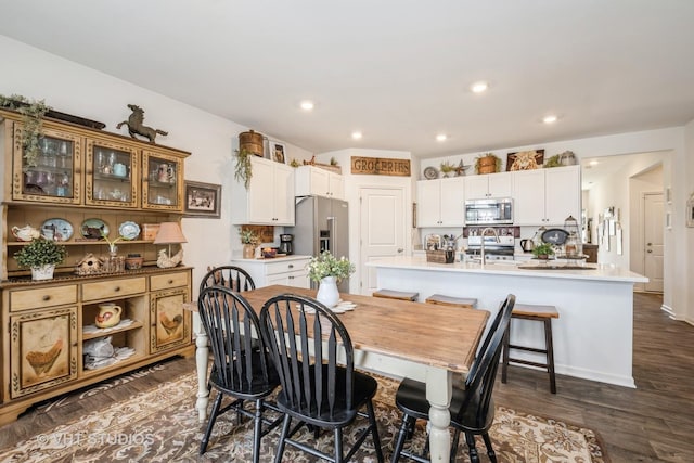dining space with dark wood-type flooring and recessed lighting
