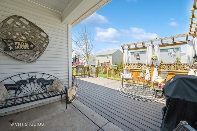 wooden deck with a grill and a pergola