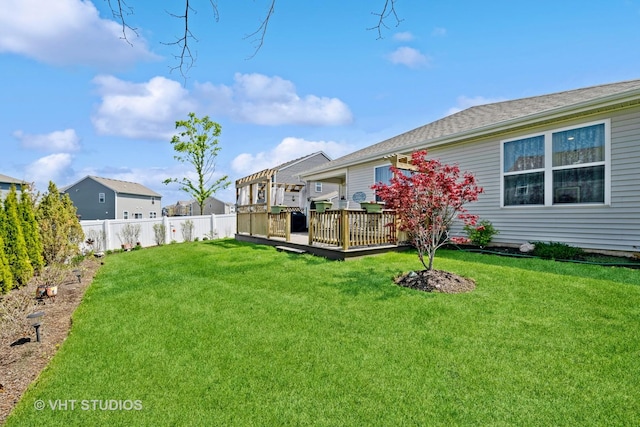 view of yard with a wooden deck and a residential view