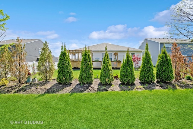 back of property featuring a lawn and a wooden deck
