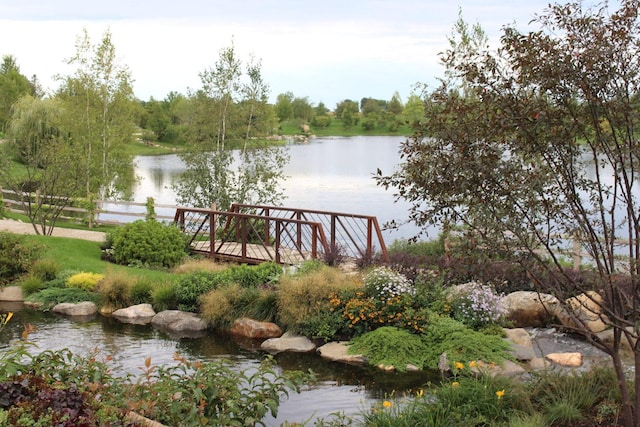 dock area featuring a water view and fence