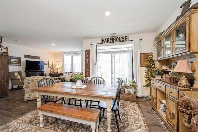 dining room with dark wood-type flooring and recessed lighting