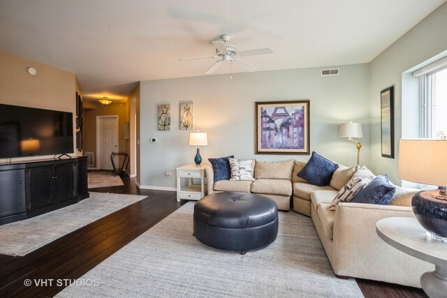 living room with visible vents, a ceiling fan, baseboards, and dark wood-style floors