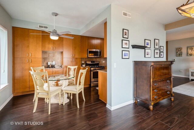 dining space featuring baseboards, ceiling fan, dark wood finished floors, and visible vents