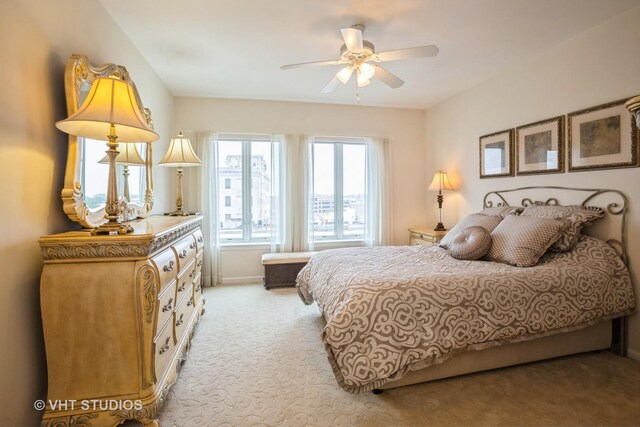 bedroom featuring baseboards and light colored carpet