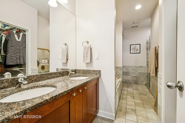 521 N Racine Ave Unit 3, Chicago, IL 60642 - full bathroom with double vanity, a garden tub, baseboards, and tile patterned flooring