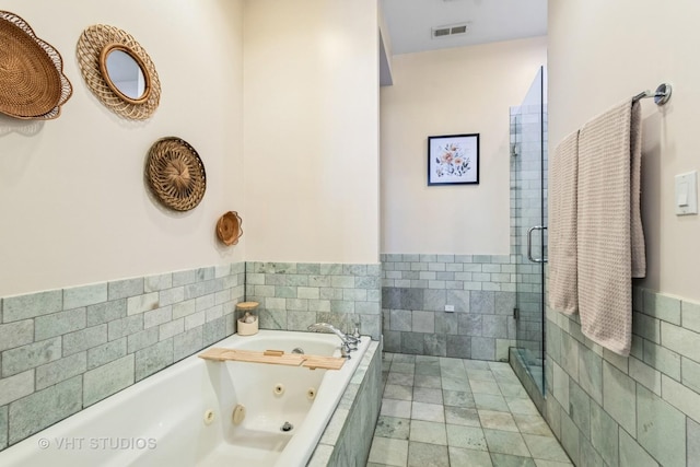 521 N Racine Ave Unit 3, Chicago, IL 60642 - full bath featuring a tub with jets, a stall shower, and a wainscoted wall